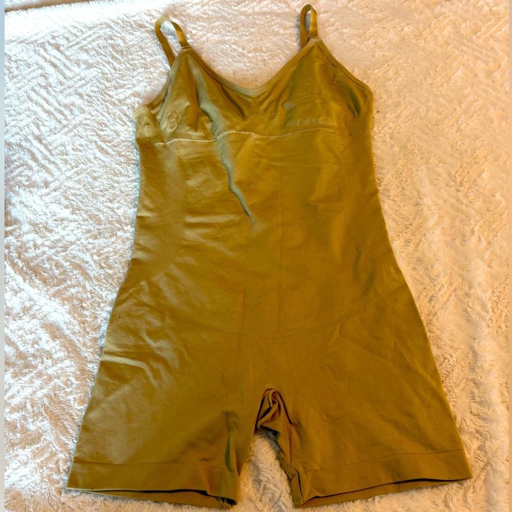 Undergarment tan body cinching girdle.